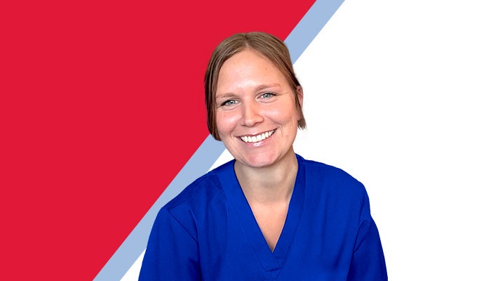 Smiling photo of Breanna Thomas, a woman with short blonde hair, blue eyes, wearing bright blue scrubs.